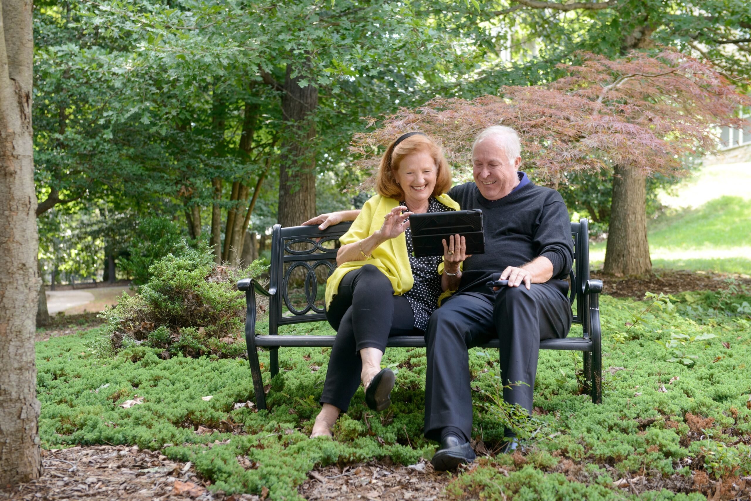 Couple enjoying a peaceful moment on a bench at Deerfield Episcopal Retirement Community