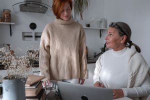 Two women talking at a kitchen table