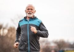 Active senior man is jogging. Healthy retirement lifestyle.